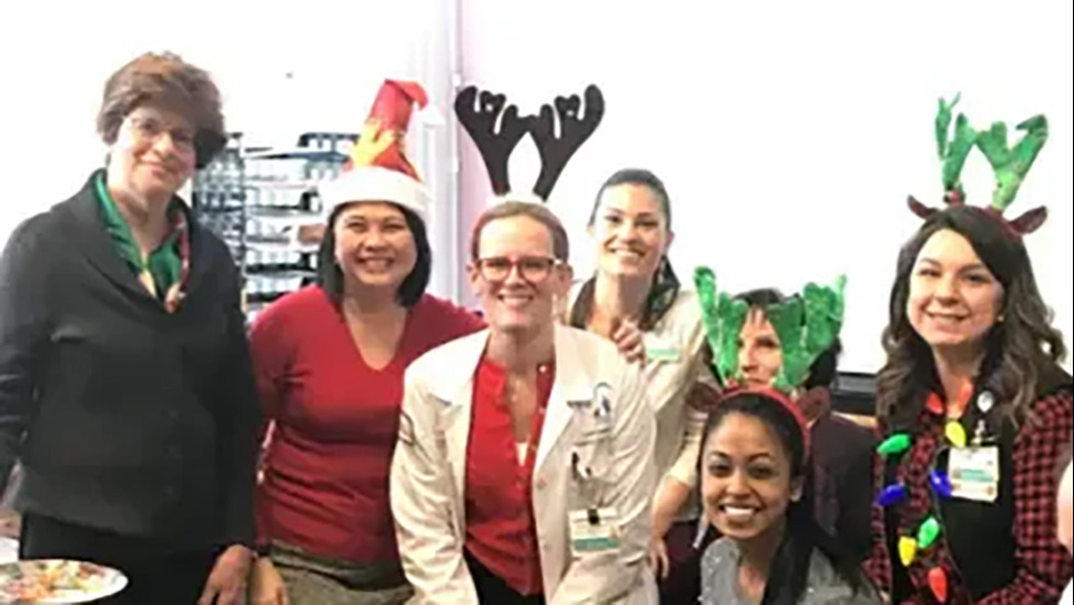 people dressed up for christmas and posing for a photo