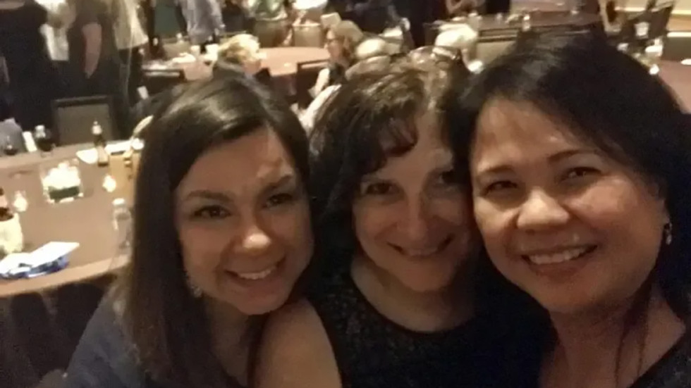 three people posing for a photo