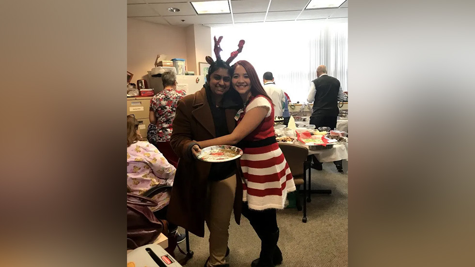 two people posing together at a holiday party