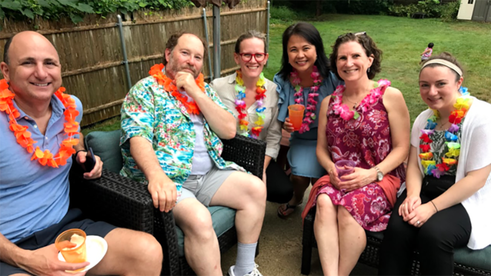 several people outside wearing Hawaiian leis