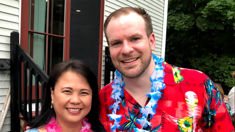 two people posing for a photo outside