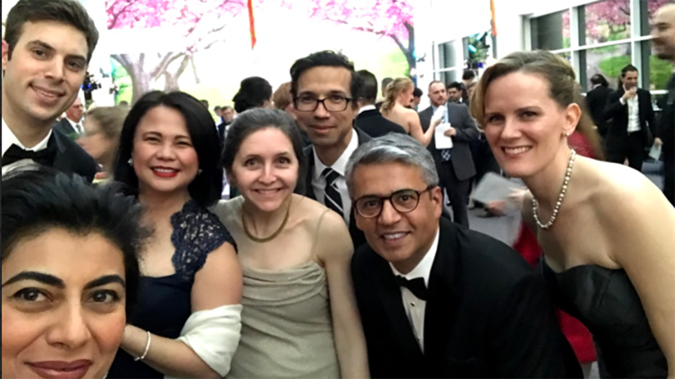 several people posing for a photo at a formal event