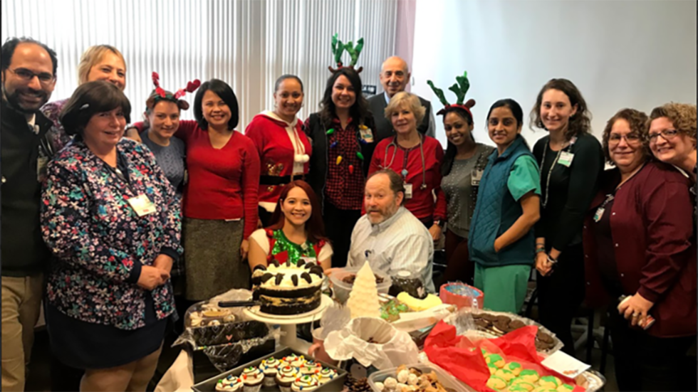 several people posing for a photo at a holiday party