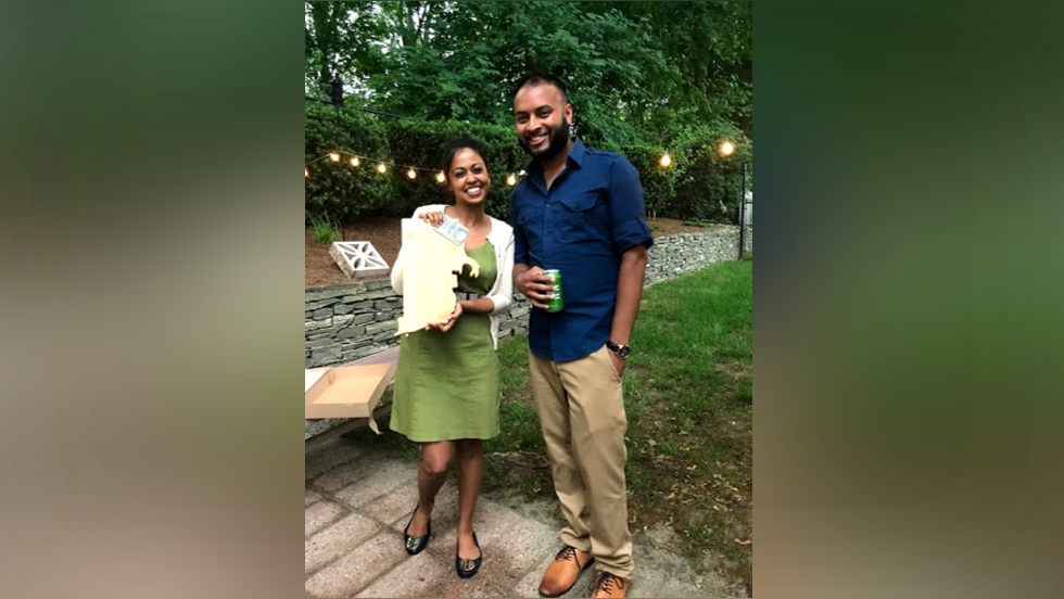 two people posing for a photo outside