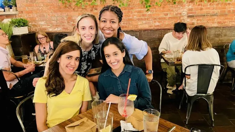 four people posing for a photo at a restaurant