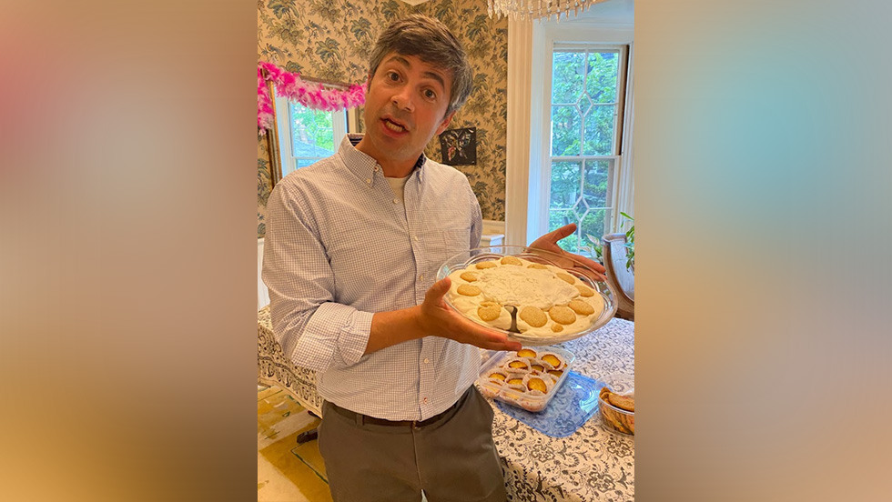 person posing for a photo and holding a pie